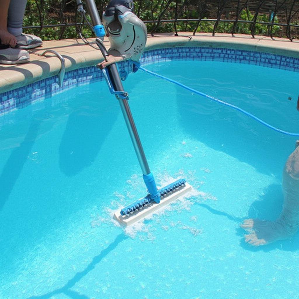 Cleaning a pool liner with a brush