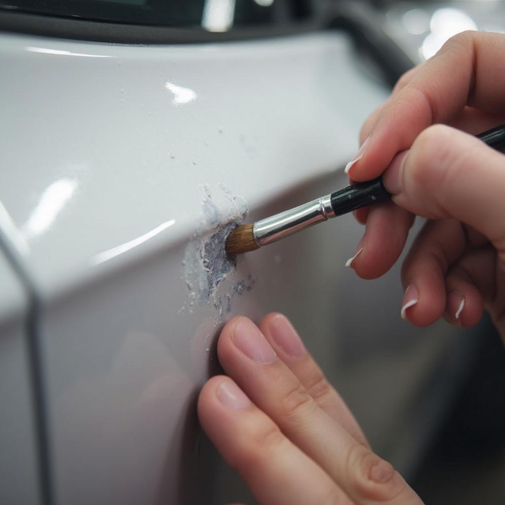 Applying touch-up paint to a car scratch