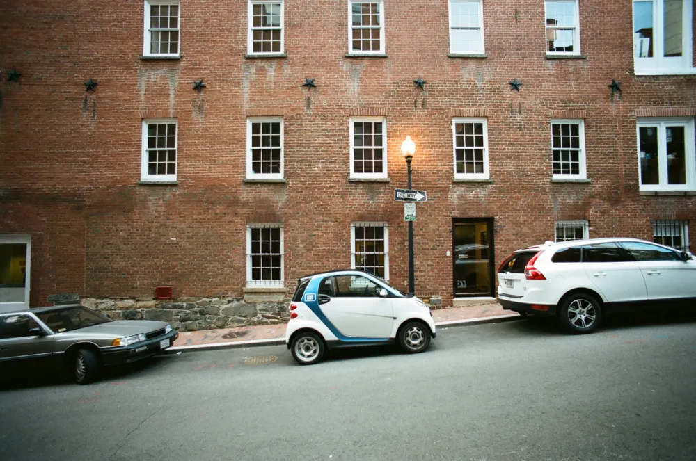 Smart car parked inefficiently on a city street