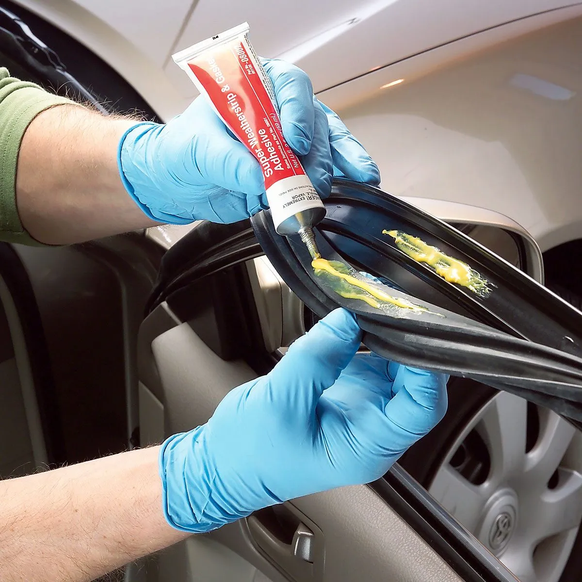 Applying glue on the stripping of the car door