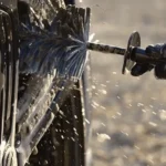 Car with soap bubbles being washed.