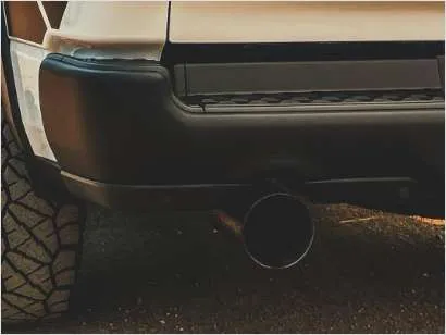 alt text: Close up view of a car's dual exhaust system.