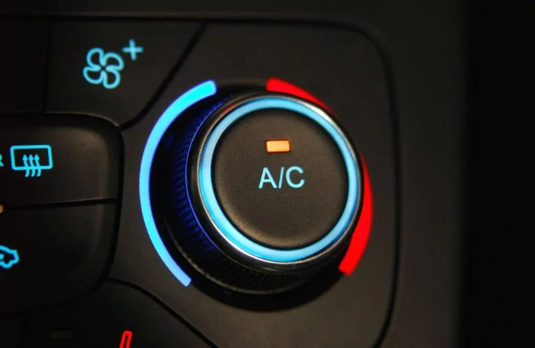 A mechanic is shown changing the oil in a car.